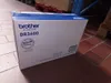 A Brother DR3600 drum unit box is shown in a warehouse setting. Náhled obrázku produktu