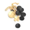 A collection of gold and black gamepad replacement parts, including joysticks, paddles, and buttons, arranged on a white background. Produktbild-Vorschau