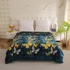 A blanket with a butterfly pattern is laid out on a bed. Produktbild-Vorschau