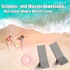 Two children playing on a beach with a pink inflatable ring and two folded beach chairs. Produktbild-Vorschau