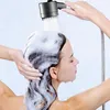 A woman is showering and washing her hair with shampoo, using a handheld showerhead. Anteprima dell’immagine prodotto