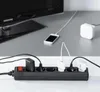 A power strip with multiple devices plugged in, including a phone charging next to a TV. Voir les images du produit