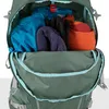 The inside of a green backpack is shown, packed with various items. Produktbild-Vorschau
