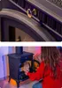 A collage showing a close-up of a stove's vent and a woman loading wood into a stove. Voir les images du produit