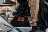 A person wearing dirty work boots stands on a step stool in a construction environment. Anteprima dell’immagine prodotto