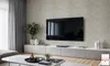 A modern living room with a large TV mounted on a wall above a sleek media console. A coffee table with decorative items is in the foreground. Produktbild-Vorschau