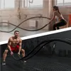 A split image showing two people using battle ropes in a gym setting. Produktbild-Vorschau