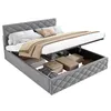 A grey upholstered bed with its storage compartment open, revealing various storage boxes and folded linens inside. The bed is made up with pillows and a blanket. Náhľad obrázku produktu