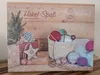 An advent calendar with a Christmas theme, featuring yarn and crochet supplies. Produktbild-Vorschau