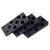 A stack of black wedges with circular indentations. Anteprima dell’immagine prodotto