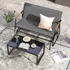 A patio scene with a two-seater glider bench, a coffee table, and a rug. Náhled obrázku produktu