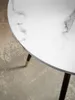 A close-up of a round table with a marble-look top and three legs. Produktbild-Vorschau