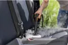 A person is using a steam cleaner on a car seat, with steam rising from the seat. Náhled obrázku produktu