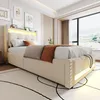 A modern bedroom with a beige upholstered bed featuring LED lighting and a large window with a view. Anteprima dell’immagine prodotto