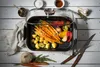 A roasting pan filled with vegetables and potatoes, surrounded by ingredients and kitchen utensils. Produktbild-Vorschau