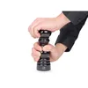Hands are shown operating a black pepper mill. Produktbild-Vorschau