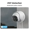 A white security camera is mounted on a gray wall, with rain depicted on the left side of the image. Produktbild-Vorschau