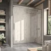 A modern bathroom with a glass shower enclosure, shelves with baskets, and a plant. Produktbild-Vorschau