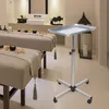 A spa or massage room with two massage beds and a rolling trolley. Náhled obrázku produktu