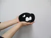 Two hands holding a plush toy of a Bullet Bill from the Super Mario video game series against a white background. Anteprima dell’immagine prodotto