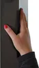 A close-up of a hand with red nail polish touching a dark gray surface, likely part of a product. Produktbild-Vorschau