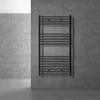 A dark anthracite radiator mounted on a textured gray tiled wall in a modern bathroom setting. Náhľad obrázku produktu