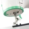 A close-up view of the needle and presser foot of a sewing machine. Produktbild-Vorschau