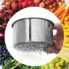 A hand holding a stainless steel colander over a background collage of various fruits and vegetables. Náhled obrázku produktu