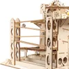 A close-up view of a wooden marble run construction kit. Voir les images du produit