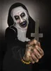 A person in a nun costume holding a cross. Produktbild-Vorschau