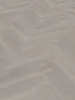 A close-up view of a herringbone-patterned vinyl floor. Produktbild-Vorschau