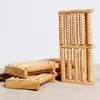 Several wooden foot massagers are arranged on a textured surface. Náhľad obrázku produktu