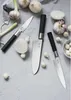 A collection of knives and garlic on a gray surface. Náhľad obrázku produktu