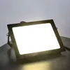 A black LED floodlight is shown on a dark surface with a light gray background. Náhled obrázku produktu