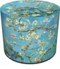 A cylindrical pouf with a print of almond blossoms on a blue background. Produktbild-Vorschau