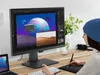 A person is using a BenQ PD2705Q monitor to edit images on a desk. Produktbild-Vorschau
