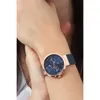 A close-up shot of a woman's wrist wearing a Tommy Hilfiger watch. Produktbild-Vorschau