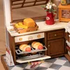 A miniature kitchen scene with baked goods and accessories. Náhľad obrázku produktu