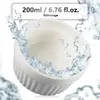 A white ceramic ramekin is shown with water splashing around it, suggesting its use for cooking or baking. Produktbild-Vorschau