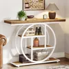 A console table with a round shelf unit is placed against a wall, next to a leather armchair. The table is decorated with books, a plant, a lamp, and decorative items. Anteprima dell’immagine prodotto