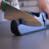 A person is sharpening a knife using a knife sharpener. Produktbild-Vorschau