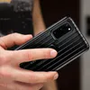 A hand holding a black Samsung phone with a protective case. Náhled obrázku produktu