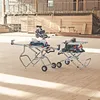 Two Bosch power tools, a miter saw and a table saw, are set up on their respective stands in a construction or workshop environment. Voir les images du produit