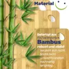 A close-up of bamboo cutting boards with bamboo stalks and leaves. Produktbild-Vorschau