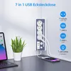 A corner of a desk with a laptop, a plant, and a power strip mounted on the wall. Produktbild-Vorschau