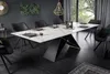 A modern dining room with a large marble-effect dining table and chairs. Produktbild-Vorschau