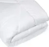 A white comforter is folded and placed on a white background. Produktbild-Vorschau