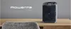 A Rowenta electric heater is placed on a wooden table next to a chair, with the Rowenta logo displayed on a gray background. Anteprima dell’immagine prodotto