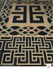 A close-up view of a textured surface with a geometric pattern in black and tan. Produktbild-Vorschau