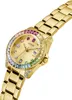 A close-up, angled shot of a gold Guess watch with a rainbow-colored bezel and dial. Produktbild-Vorschau